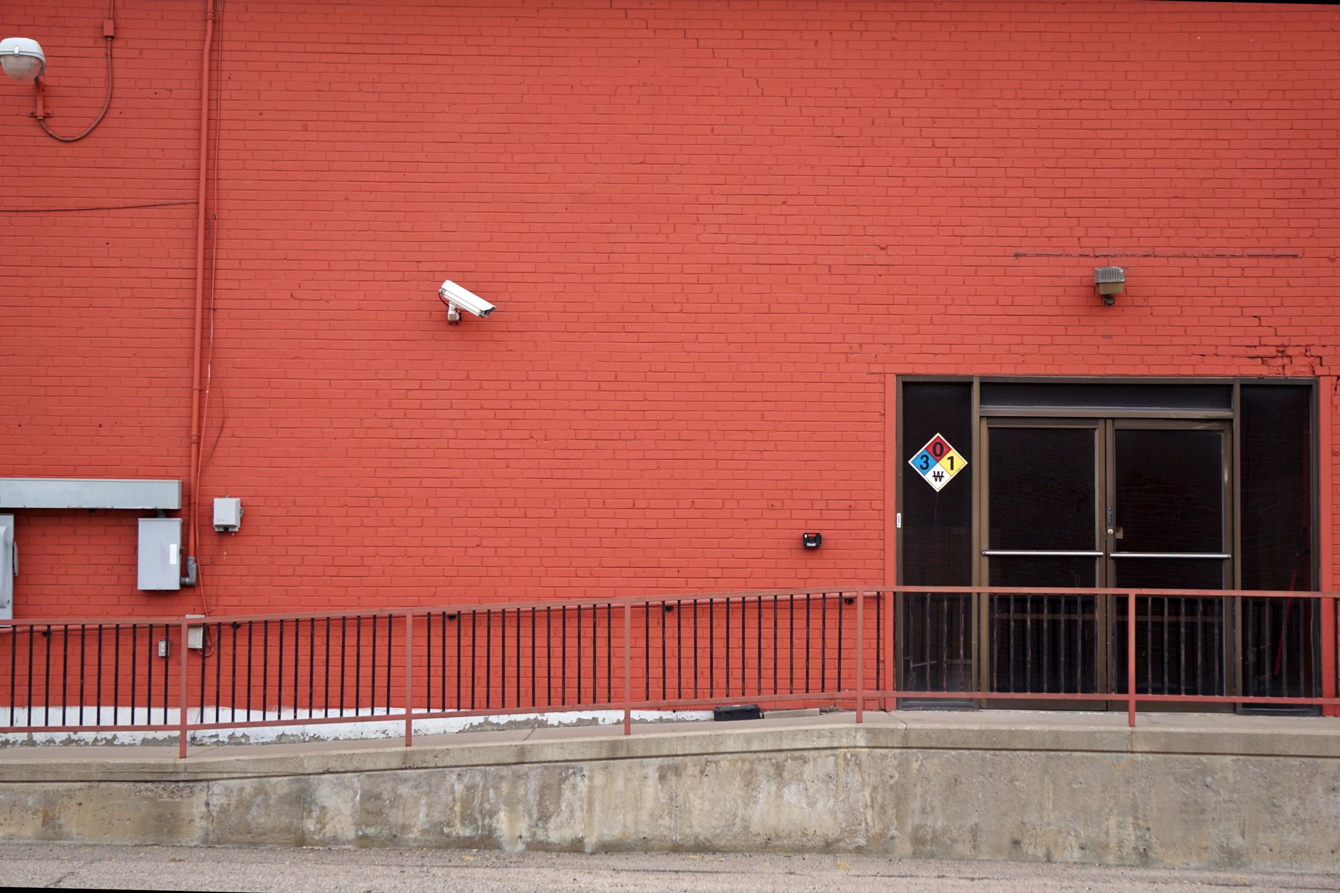Digital security cameras mounted on a Lafayette LA commercial building exterior