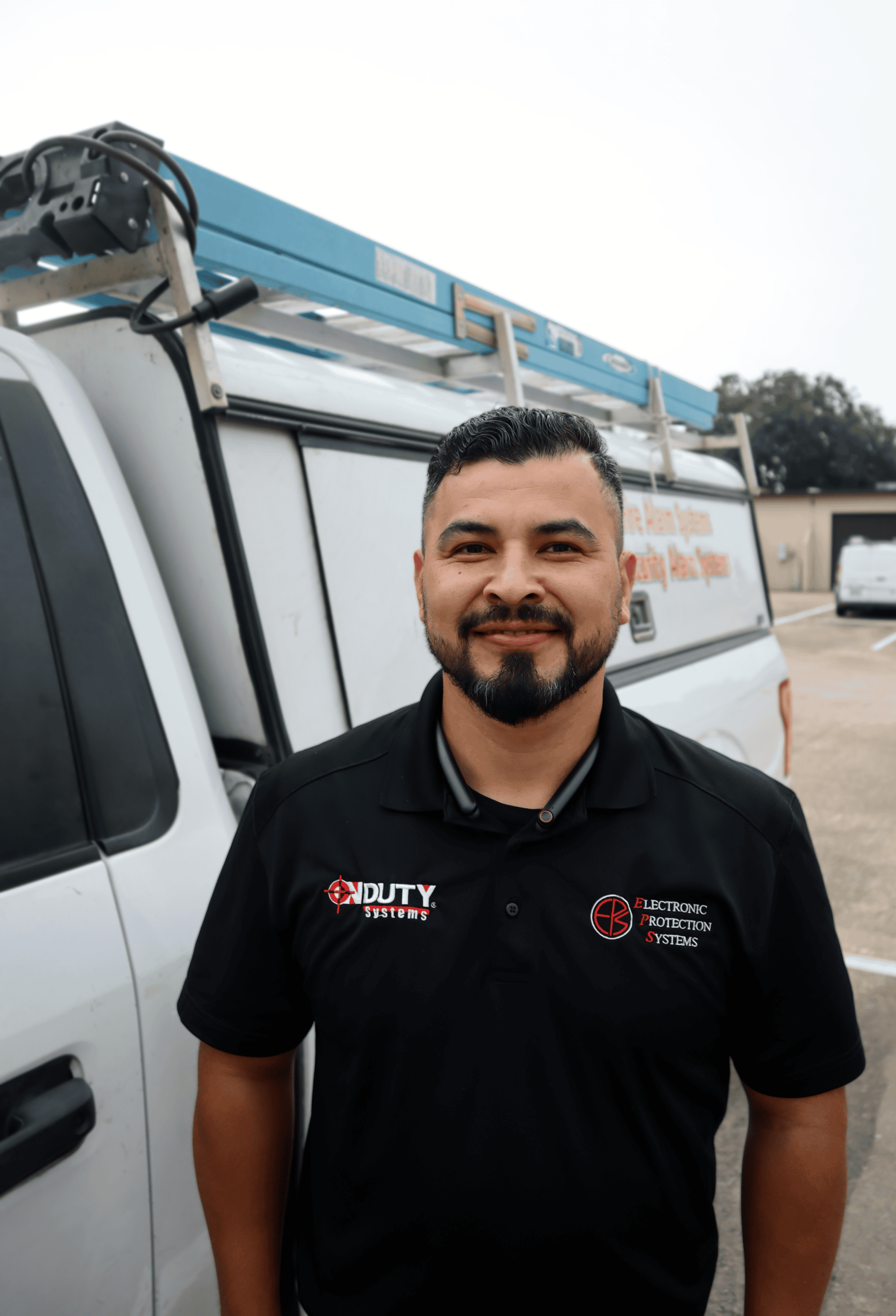 Javier Martinez, EPS Houston service technician beside an EPS service truck
