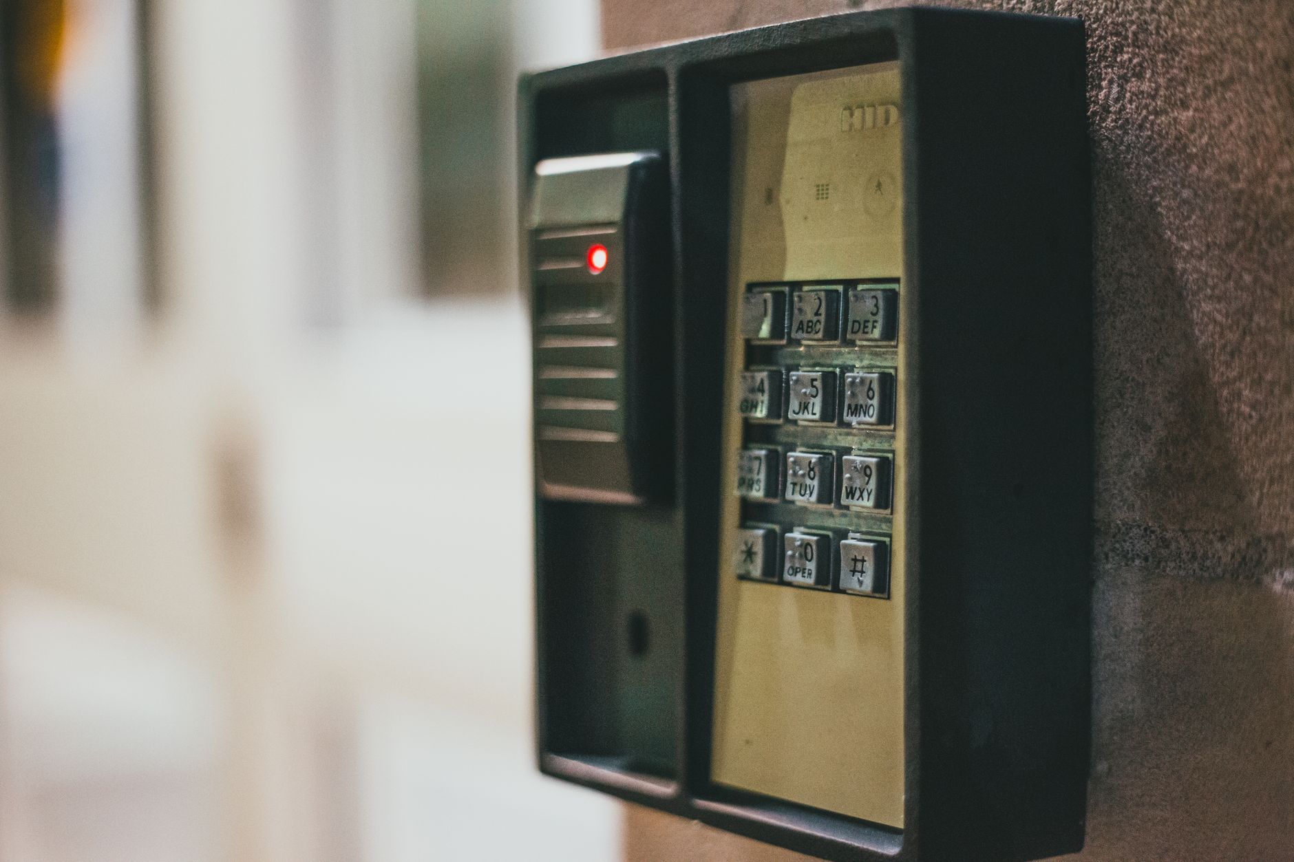 SimpliSafe for businesses wireless security panel on a small office wall